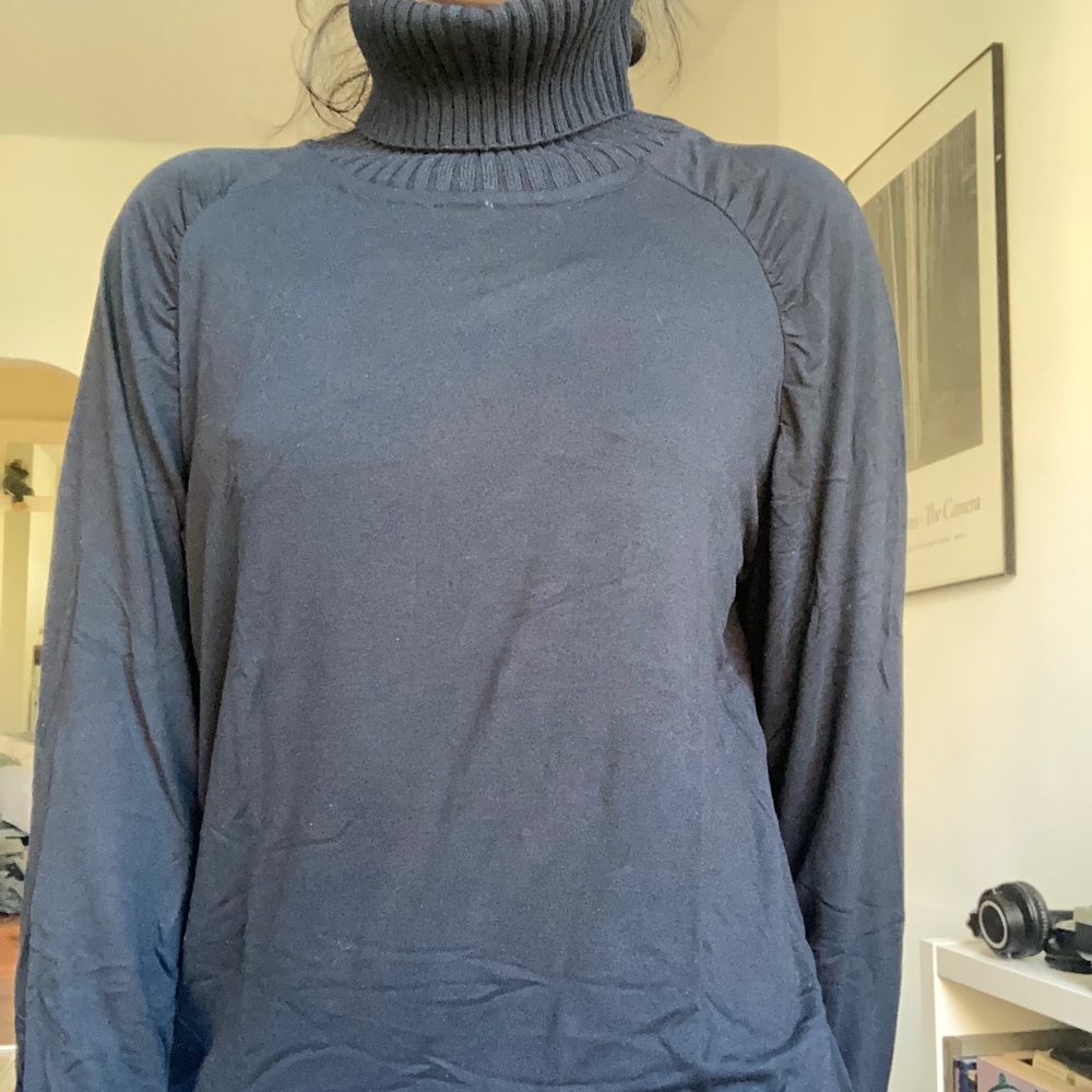 Black turtleneck with knit ribbed neck and soft flowy body